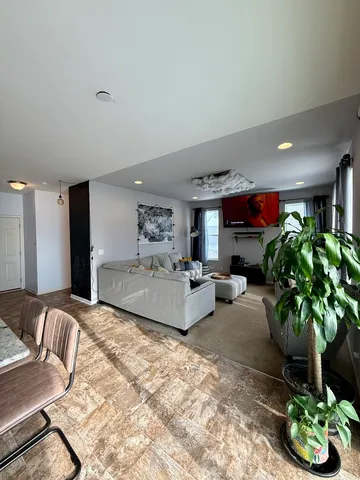 a living room with furniture potted plant and a window