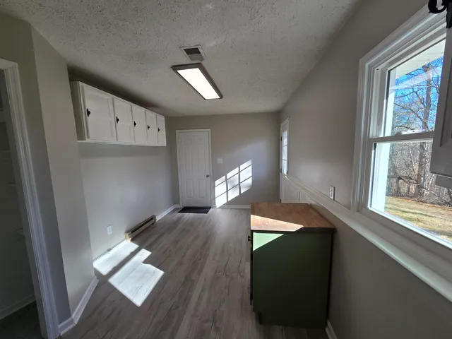 a bathroom with a toilet a sink a mirror and vanity