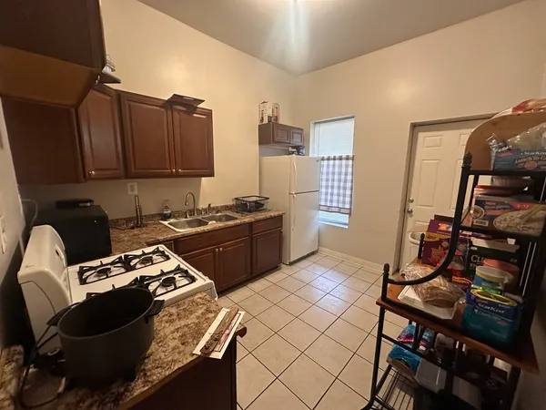 a kitchen with a stove a sink and a refrigerator