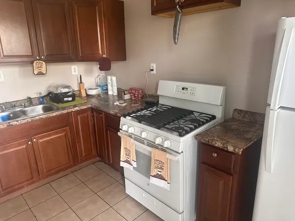 a white stove top oven sitting inside of a kitchen