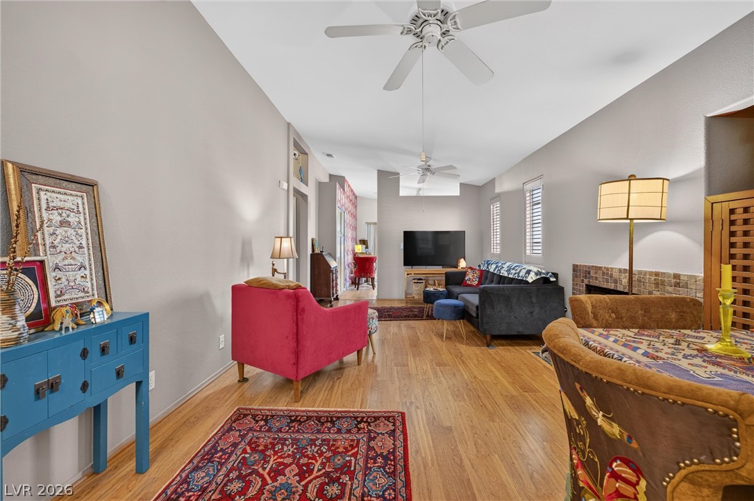 2247 Ramsgate Drive, Unit 2247 Henderson, NV 89074 - Photo 5 of 50 Vinylwood flooring extends throughout this well-lit open-concept living space, complemented by a cozy fireplace.