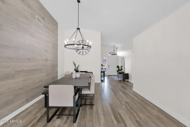 a view of a dining room with furniture wooden floor and chandelier