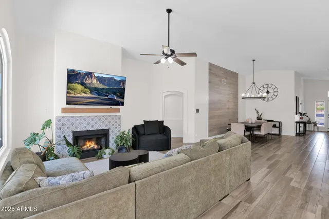 a living room with furniture a fireplace and a flat screen tv
