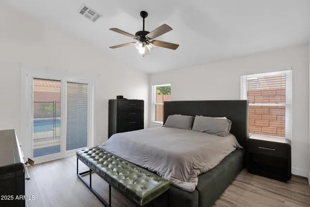 a bedroom with a bed and wooden floor