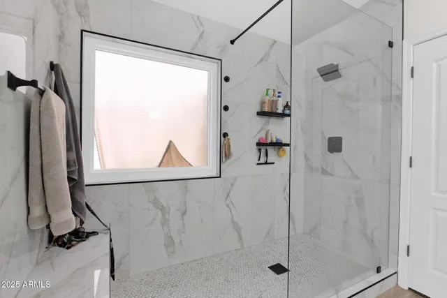 a bathroom with a shower and a glass door