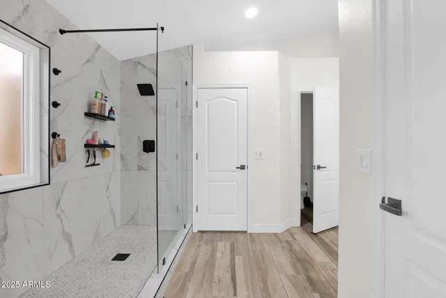 a bathroom with a shower and a glass door
