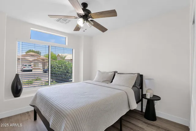 a bedroom with a bed and a window