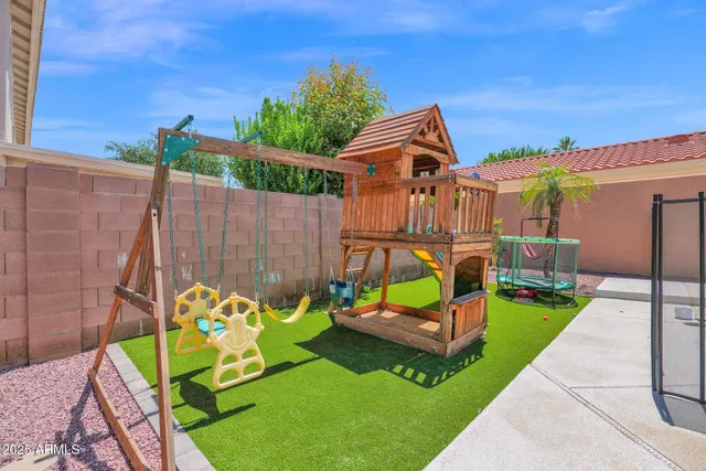 a view of a chairs and table in backyard