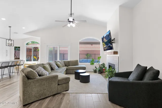 a living room with furniture and a chandelier