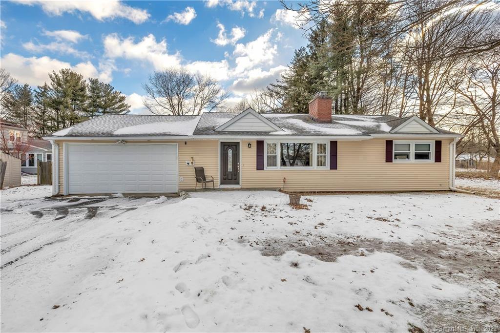 a front view of a house with a covered with trees