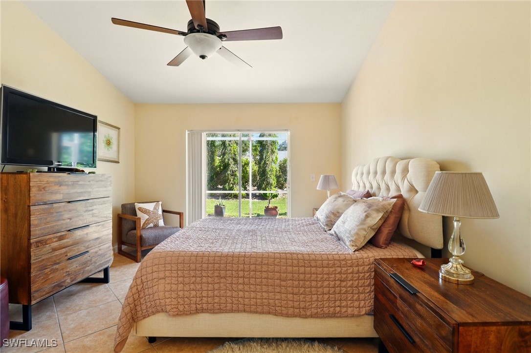 6283 Shadowood Circle Naples, FL 34112 - Photo 19 of 31 a bedroom with a bed and flat screen tv