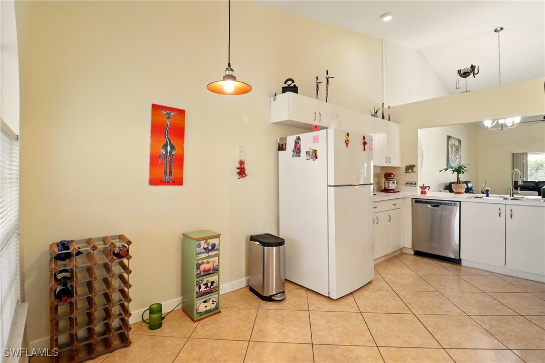 6283 Shadowood Circle Naples, FL 34112 - Photo 10 of 31 a kitchen with refrigerator and cabinets