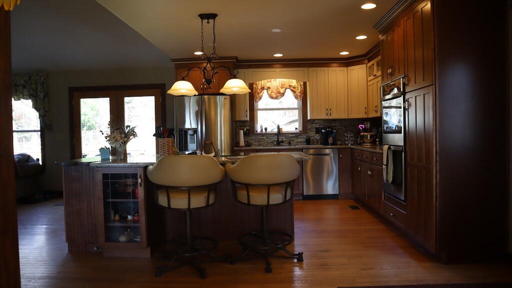 1247 Cannady School Road Southeast Floyd, VA 24091 - Photo 13 of 54 a kitchen with stainless steel appliances a dining table chairs stove refrigerator and cabinets