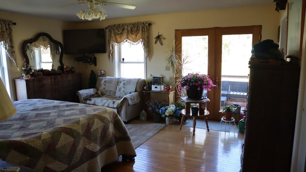 1247 Cannady School Road Southeast Floyd, VA 24091 - Photo 17 of 54 a bedroom with a bed large window and wooden floor