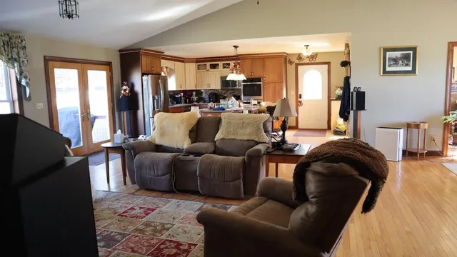 a living room with furniture and a chandelier
