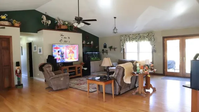 a living room with furniture chandelier and a window