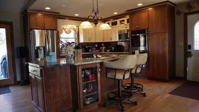 a kitchen with kitchen island a counter space a sink appliances and cabinets
