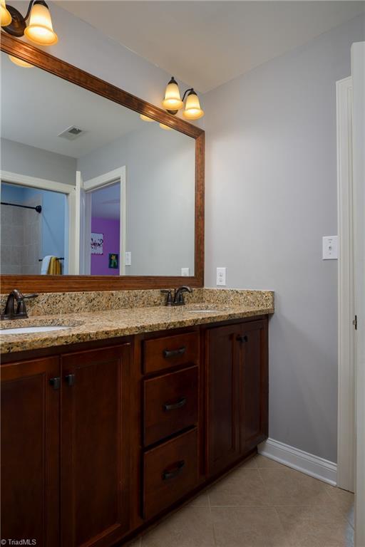 8931 Grove Park Drive Oak Ridge, NC 27310 - Photo 25 of 36 jack & jill bathroom upstairs with dual vanity