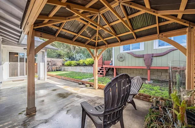 a kitchen with granite countertop a refrigerator a stove and a wooden floors