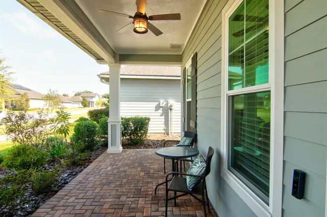 a view of a porch with chairs and backyard