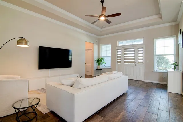a living room with a flat screen tv and a large window