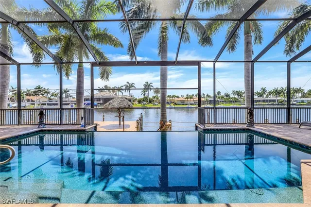 a view of an ocean with boats and palm trees