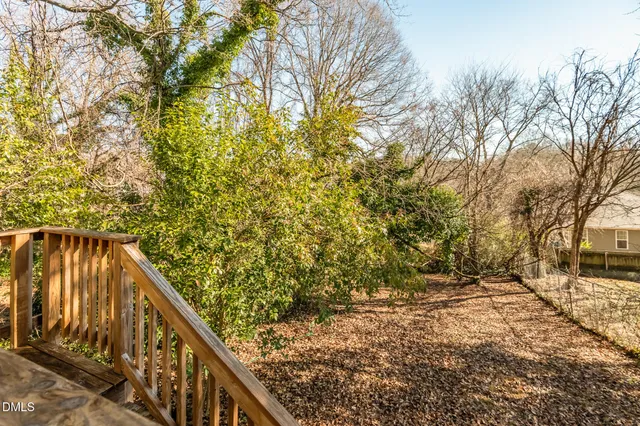 a view of balcony with wooden floor and fence