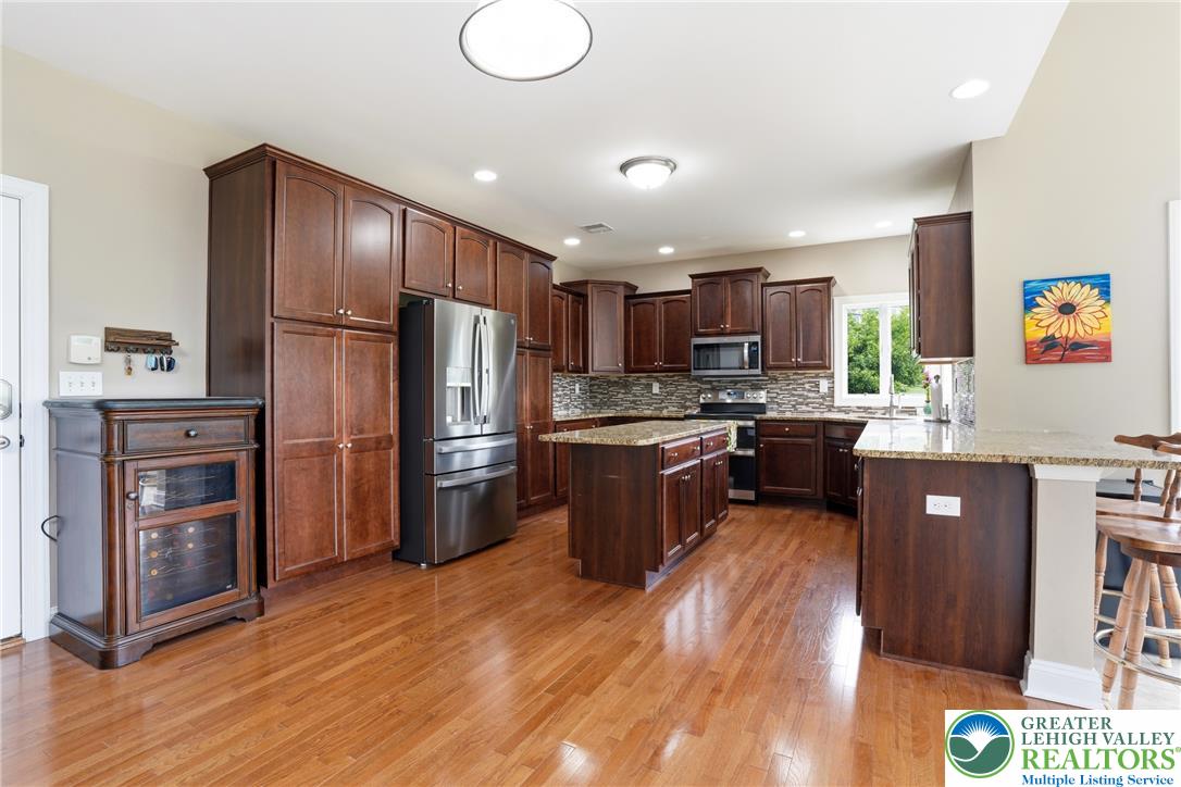 1212 Miller Road Wind Gap, PA 18091 - Photo 18 of 72 Culinary delights await in this spacious kitchen featuring rich cabinetry and a central island.