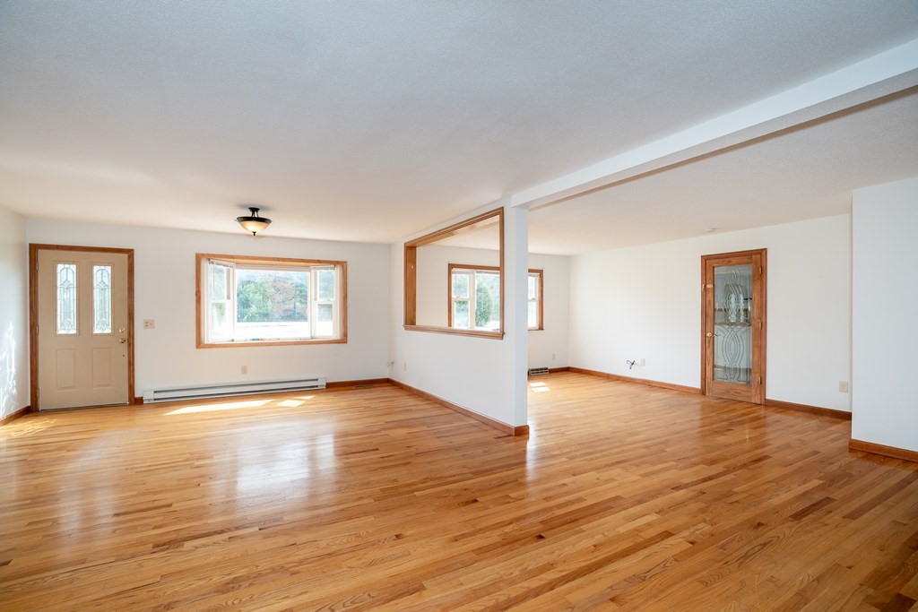 127 Upper Hampden Road Monson, MA 01057 - Photo 17 of 42 an empty room with wooden floor and windows