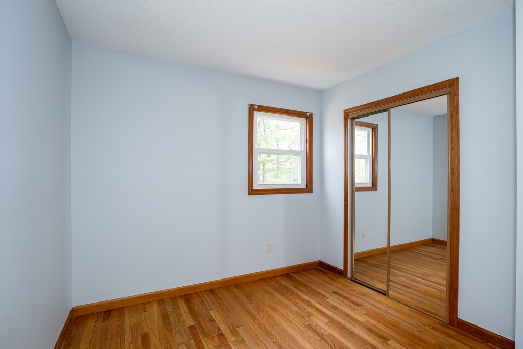 127 Upper Hampden Road Monson, MA 01057 - Photo 36 of 42 an empty room with wooden floor and windows