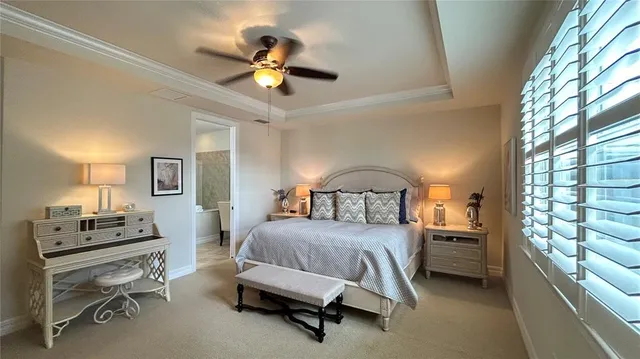 a bedroom with a bed couch and window