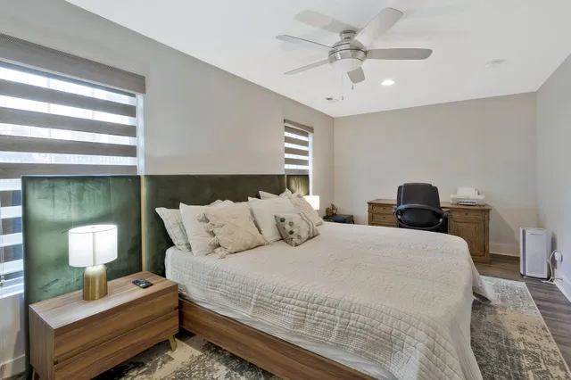 a bedroom with bed and a chandelier
