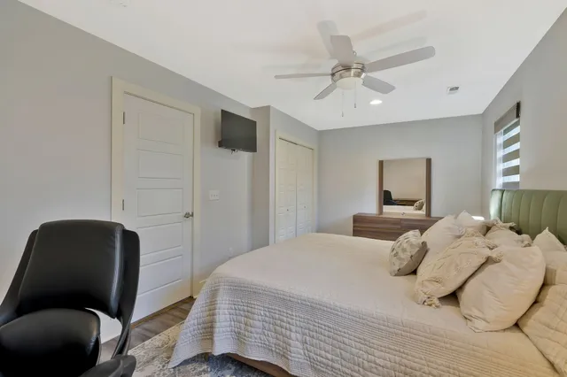 a bedroom with a bed and a chair