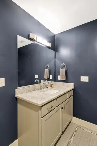 a bathroom with a sink vanity and a mirror