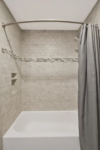 a bathroom with a shower and a bath tub