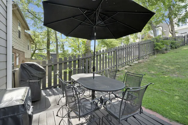 a patio with a patio table and chairs