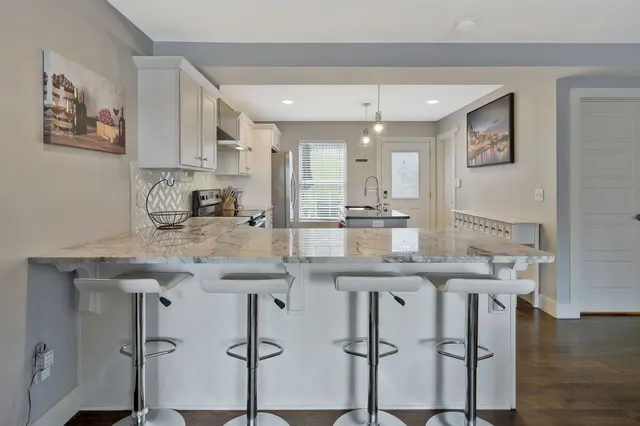 a kitchen with cabinets table and chairs