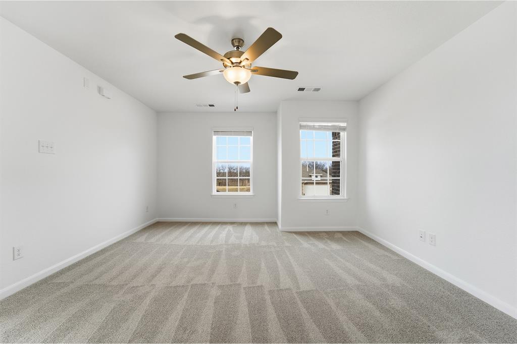 228 Charismatic Road Waxahachie, TX 75165 - Photo 13 of 23 an empty room with windows and fan