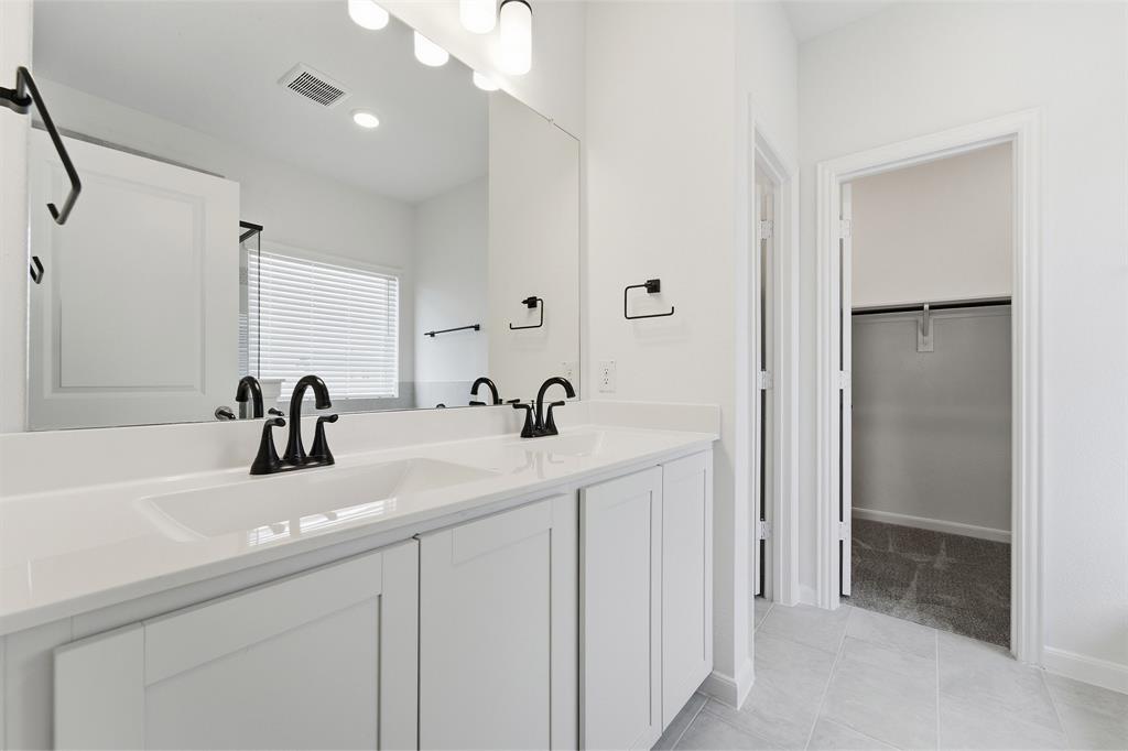 228 Charismatic Road Waxahachie, TX 75165 - Photo 14 of 23 a bathroom with double sink and a mirror