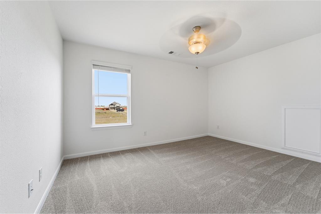 228 Charismatic Road Waxahachie, TX 75165 - Photo 16 of 23 an empty room with window and a ceiling fan