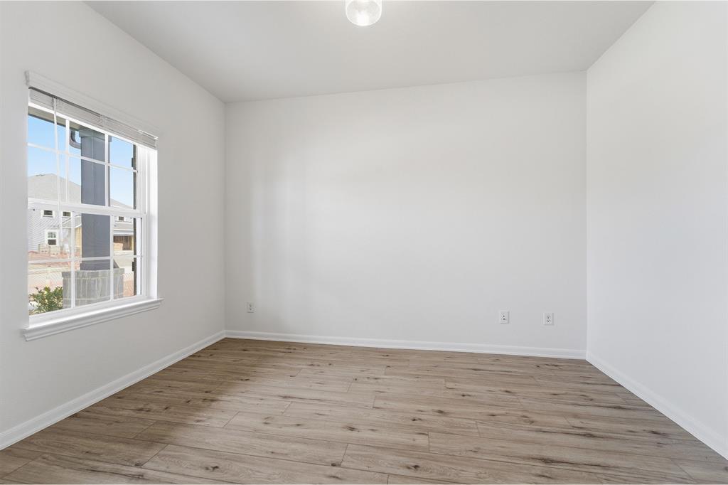 228 Charismatic Road Waxahachie, TX 75165 - Photo 17 of 23 a view of empty room with wooden floor and fan