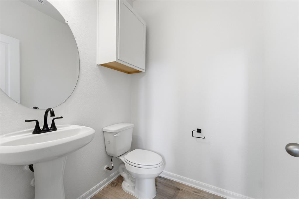 228 Charismatic Road Waxahachie, TX 75165 - Photo 18 of 23 a bathroom with a toilet sink and mirror