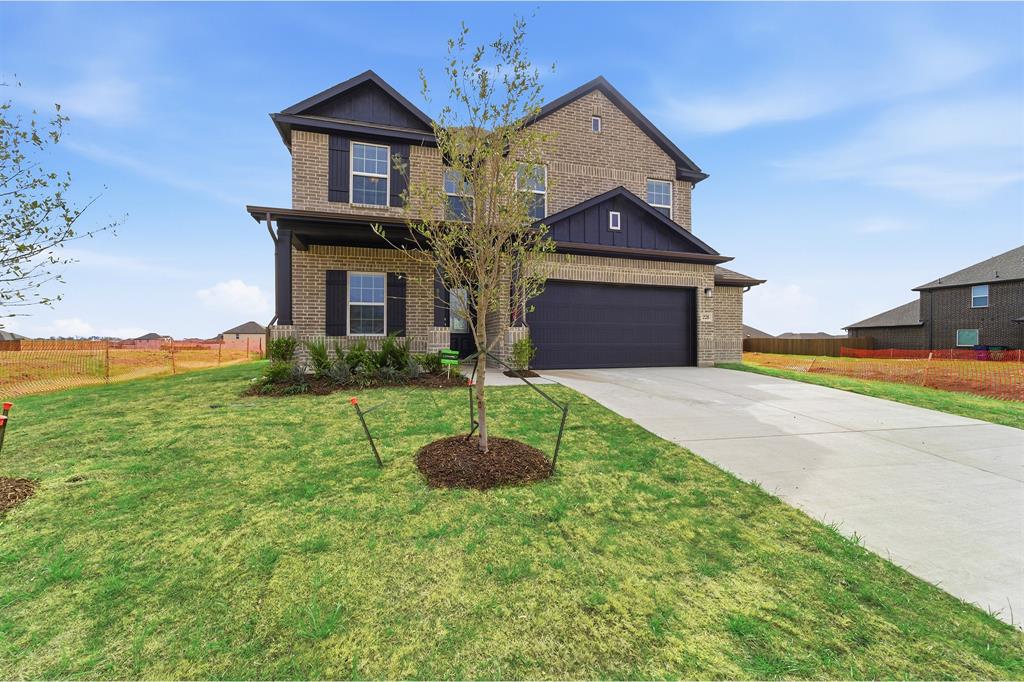228 Charismatic Road Waxahachie, TX 75165 - Photo 2 of 23 a front view of a house with a yard and garage