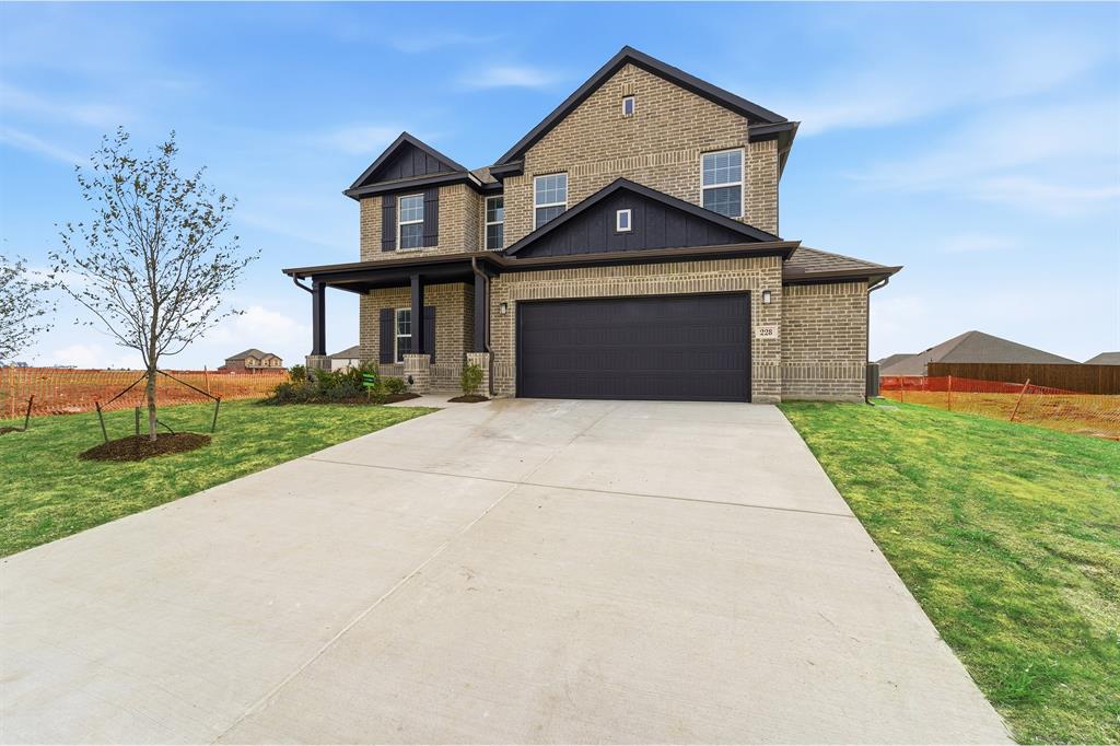 228 Charismatic Road Waxahachie, TX 75165 - Photo 3 of 23 a front view of a house with a yard