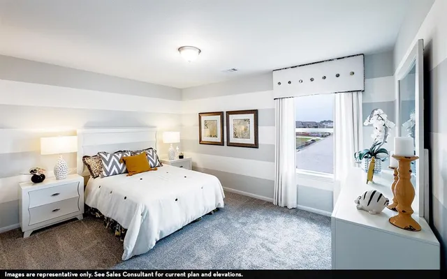 a bedroom with a bed and a view of bedroom