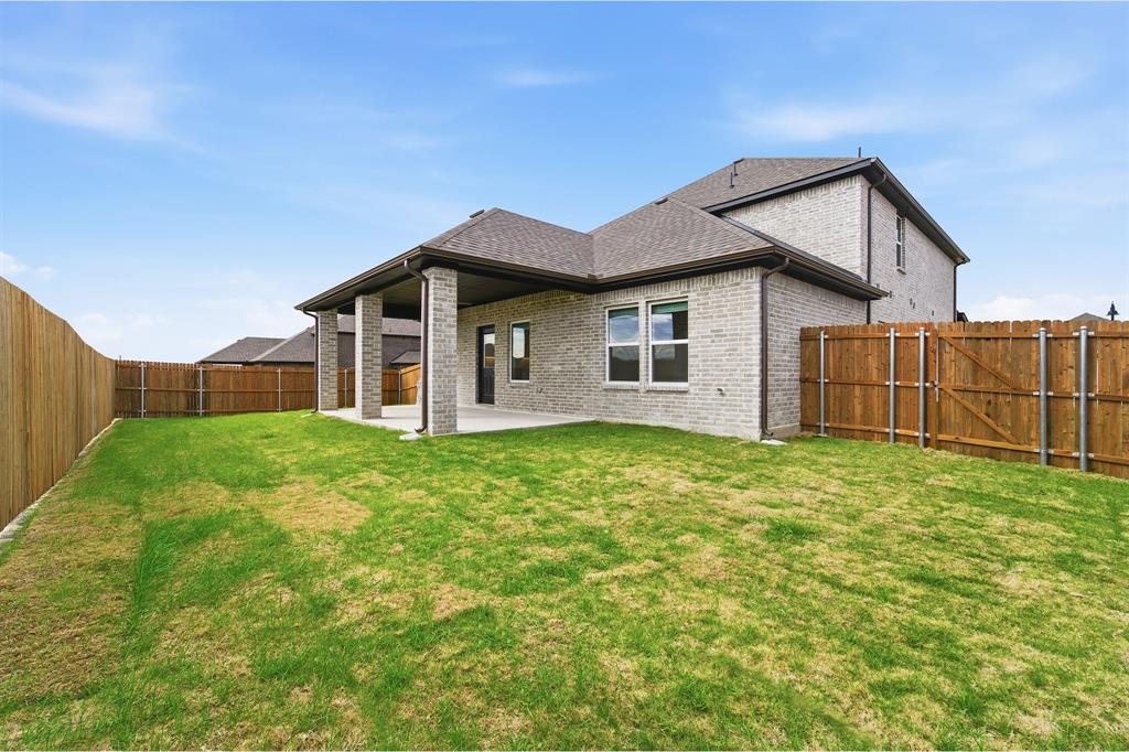 228 Charismatic Road Waxahachie, TX 75165 - Photo 4 of 23 a view of a house with backyard and garden