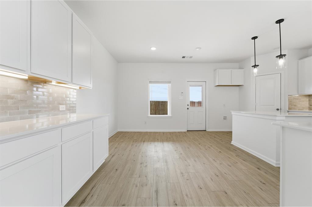 228 Charismatic Road Waxahachie, TX 75165 - Photo 9 of 23 a view of a kitchen with wooden floor