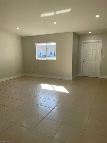 an empty room with white walls and tiles