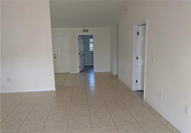 a kitchen with a refrigerator and window