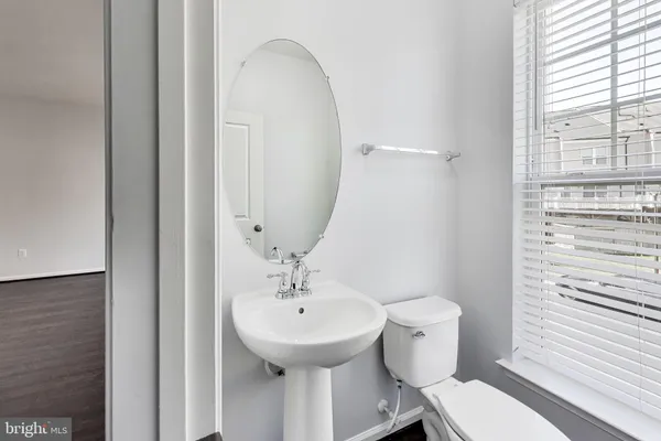 a bathroom with a sink toilet and mirror